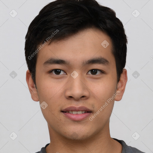 Joyful asian young-adult male with short  black hair and brown eyes