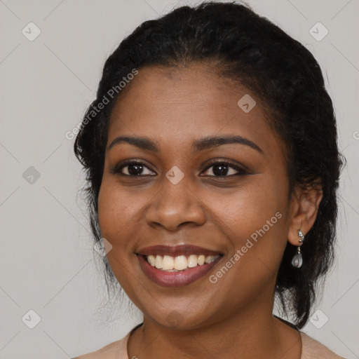 Joyful black young-adult female with long  black hair and brown eyes