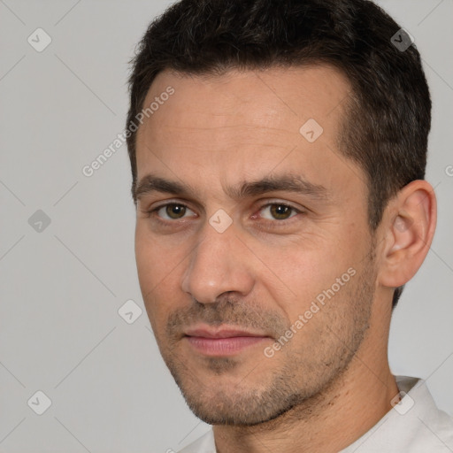 Joyful white adult male with short  brown hair and brown eyes