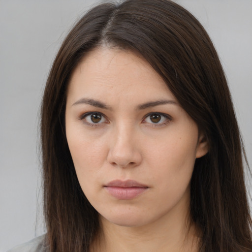 Neutral white young-adult female with long  brown hair and brown eyes