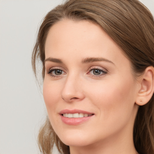 Joyful white young-adult female with long  brown hair and grey eyes