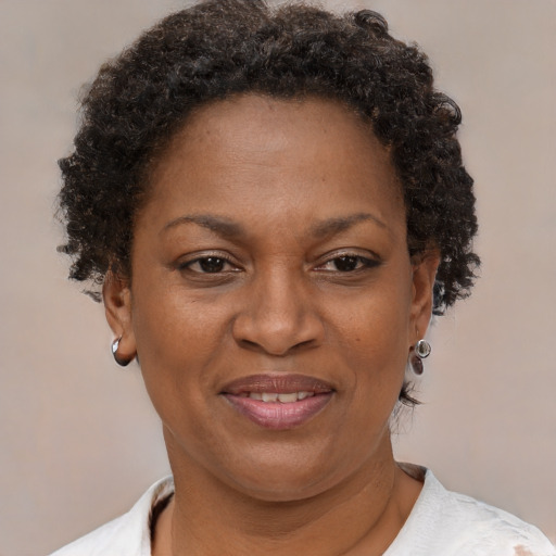 Joyful black adult female with short  brown hair and brown eyes