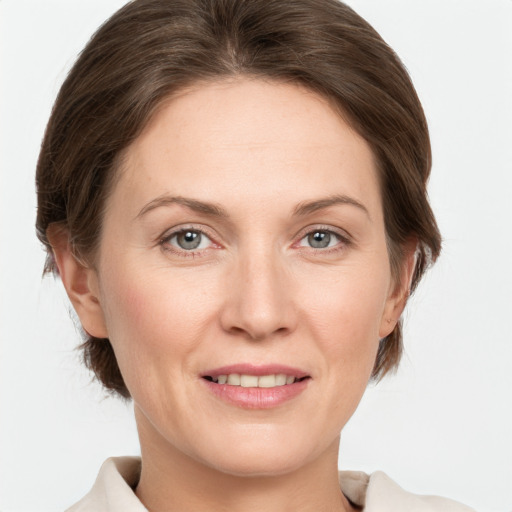 Joyful white adult female with medium  brown hair and grey eyes