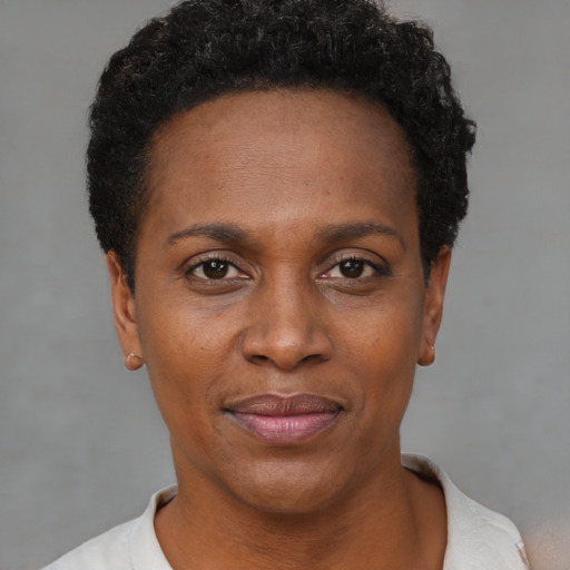 Joyful black young-adult female with short  black hair and brown eyes
