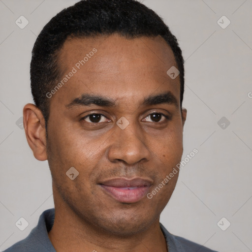 Joyful black young-adult male with short  black hair and brown eyes