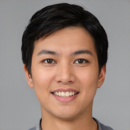 Joyful asian young-adult male with short  black hair and brown eyes