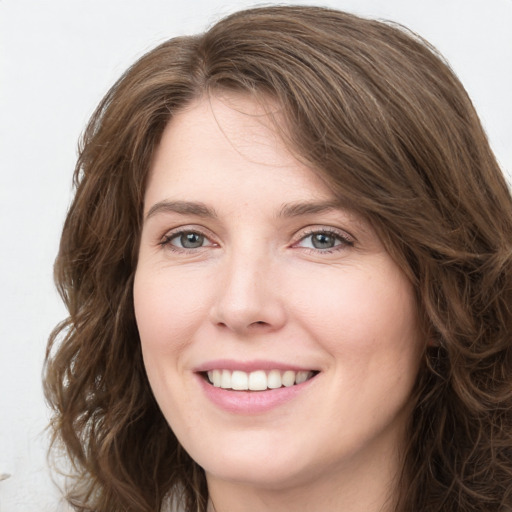 Joyful white young-adult female with long  brown hair and green eyes