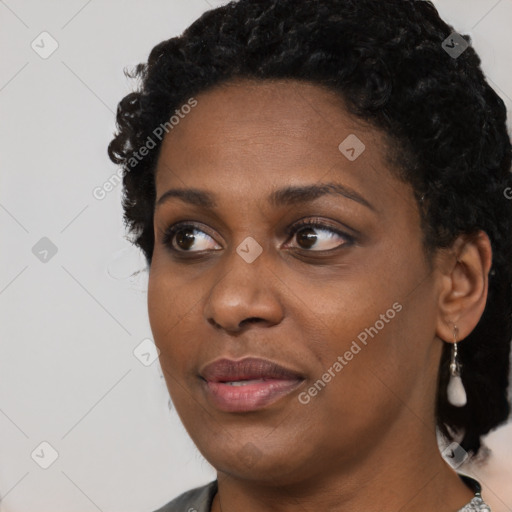 Joyful black young-adult female with medium  black hair and brown eyes