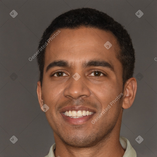Joyful black young-adult male with short  brown hair and brown eyes