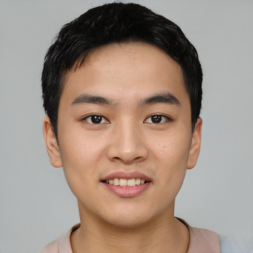 Joyful asian young-adult male with short  black hair and brown eyes