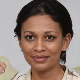 Joyful latino adult female with short  brown hair and brown eyes