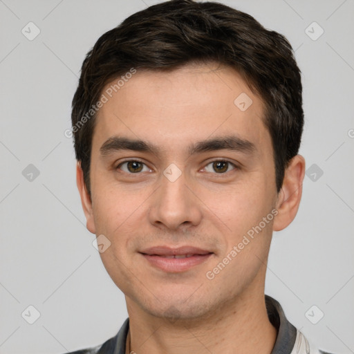 Joyful white young-adult male with short  black hair and brown eyes