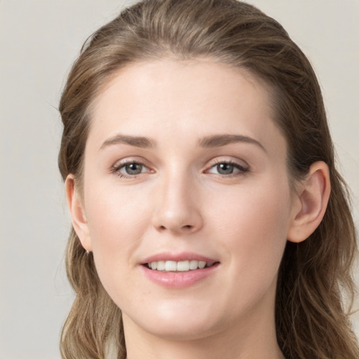 Joyful white young-adult female with long  brown hair and grey eyes