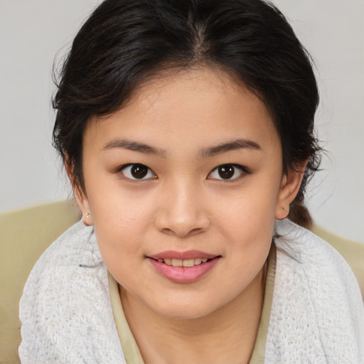 Joyful asian young-adult female with medium  brown hair and brown eyes