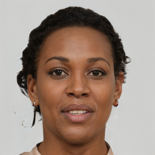 Joyful black young-adult female with short  brown hair and brown eyes