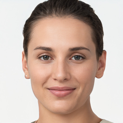 Joyful white young-adult female with short  brown hair and brown eyes