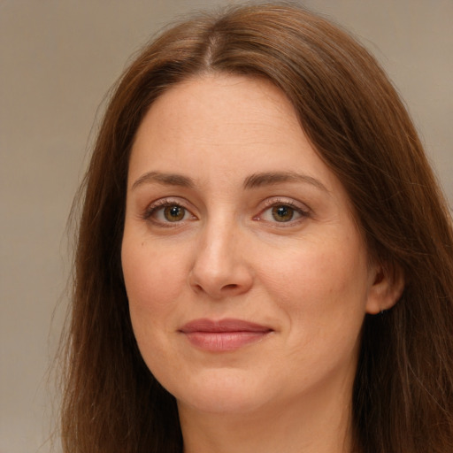 Joyful white young-adult female with long  brown hair and green eyes