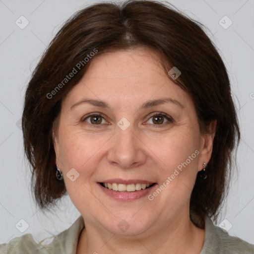 Joyful white adult female with medium  brown hair and brown eyes