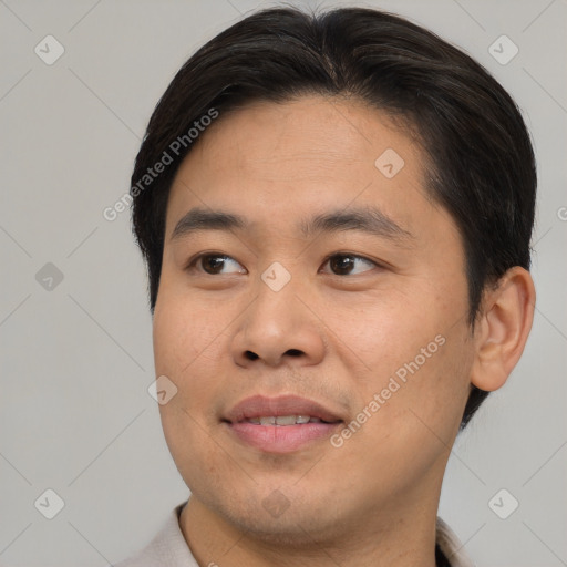 Joyful asian young-adult male with short  brown hair and brown eyes