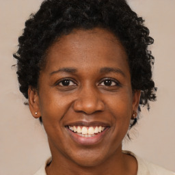 Joyful black adult female with short  brown hair and brown eyes