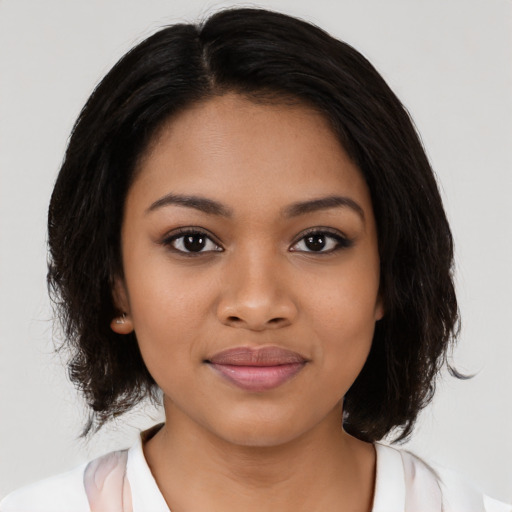 Joyful black young-adult female with medium  black hair and brown eyes