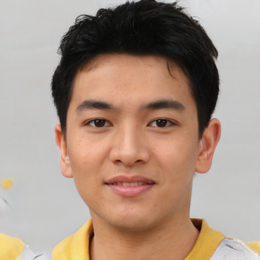 Joyful asian young-adult male with short  black hair and brown eyes