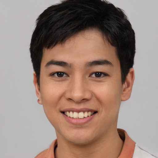 Joyful asian young-adult male with short  black hair and brown eyes