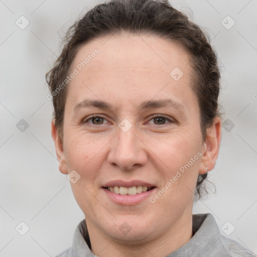 Joyful white adult female with short  brown hair and grey eyes