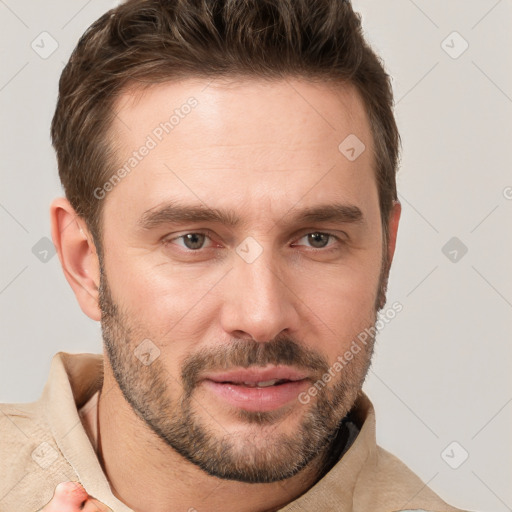 Joyful white young-adult male with short  brown hair and grey eyes