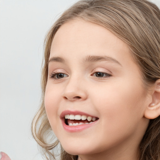 Joyful white child female with long  brown hair and brown eyes