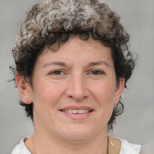 Joyful white adult female with medium  brown hair and blue eyes