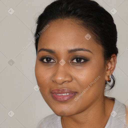 Joyful black young-adult female with medium  black hair and brown eyes