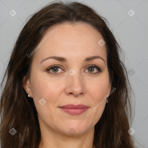 Joyful white adult female with long  brown hair and brown eyes