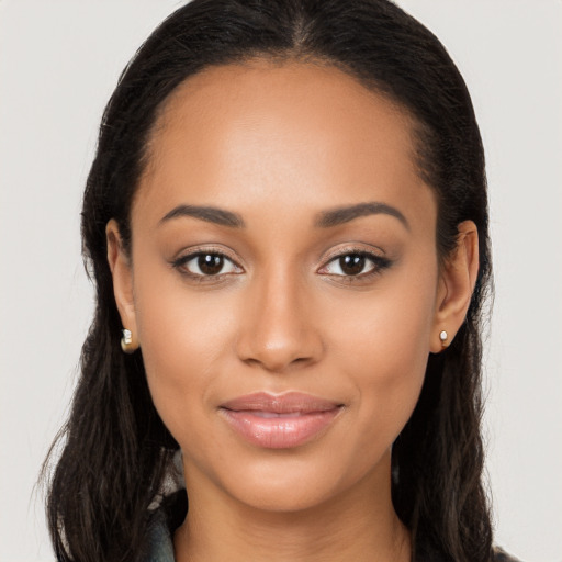 Joyful latino young-adult female with long  brown hair and brown eyes