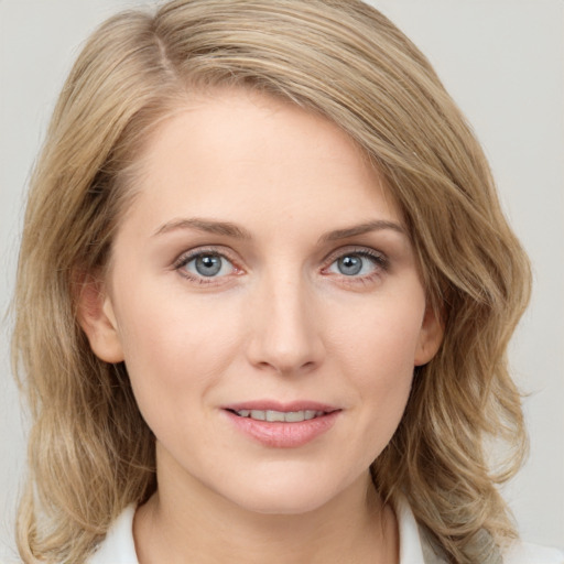 Joyful white young-adult female with medium  brown hair and blue eyes