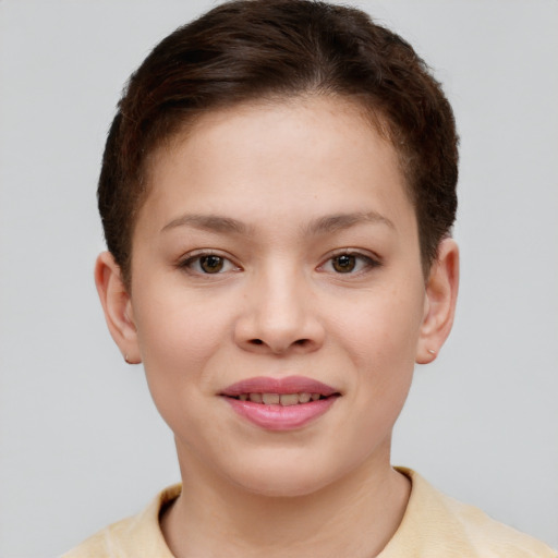 Joyful white child female with short  brown hair and brown eyes