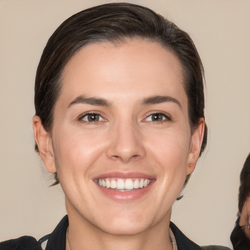 Joyful white young-adult female with medium  brown hair and brown eyes