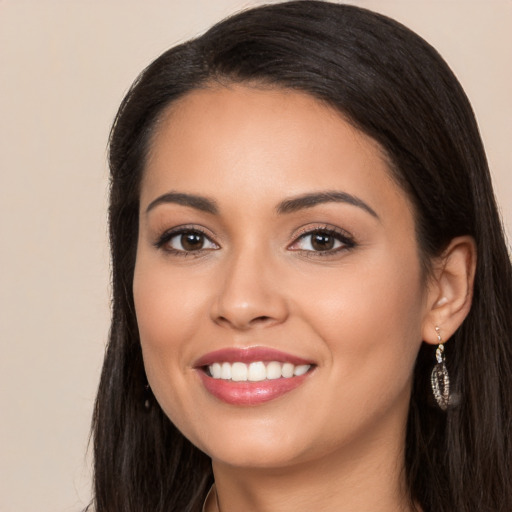 Joyful latino young-adult female with long  brown hair and brown eyes