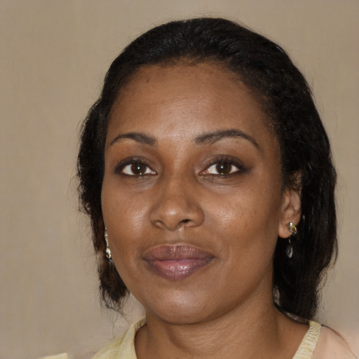 Joyful black adult female with medium  black hair and brown eyes