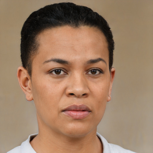 Joyful latino young-adult female with short  brown hair and brown eyes