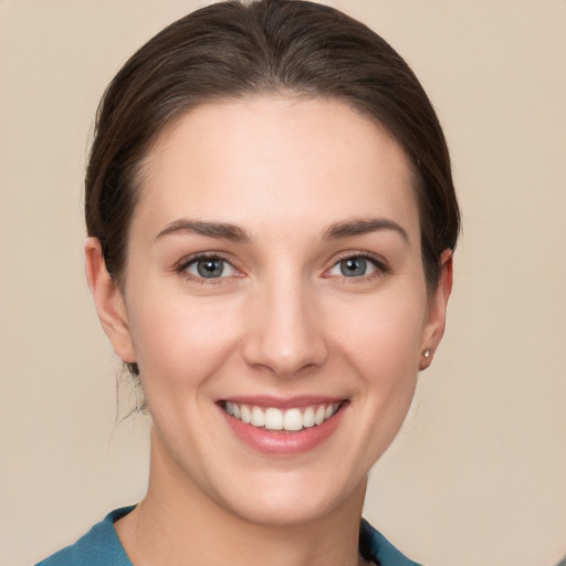 Joyful white young-adult female with short  brown hair and grey eyes