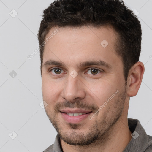 Joyful white young-adult male with short  brown hair and brown eyes