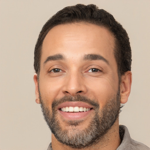 Joyful white young-adult male with short  black hair and brown eyes