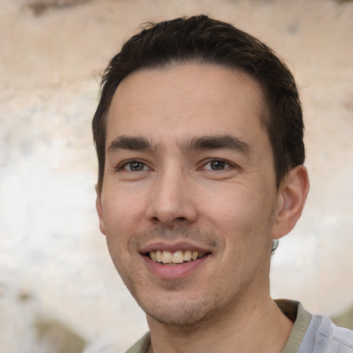 Joyful white young-adult male with short  black hair and brown eyes