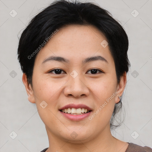 Joyful asian young-adult female with short  black hair and brown eyes