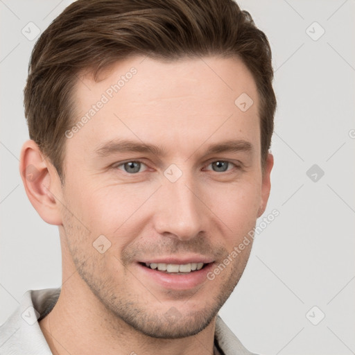 Joyful white young-adult male with short  brown hair and grey eyes