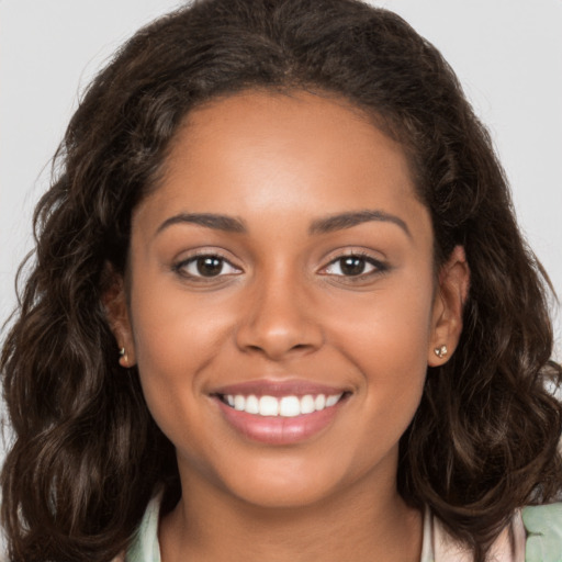 Joyful white young-adult female with long  brown hair and brown eyes