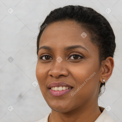 Joyful black young-adult female with short  brown hair and brown eyes