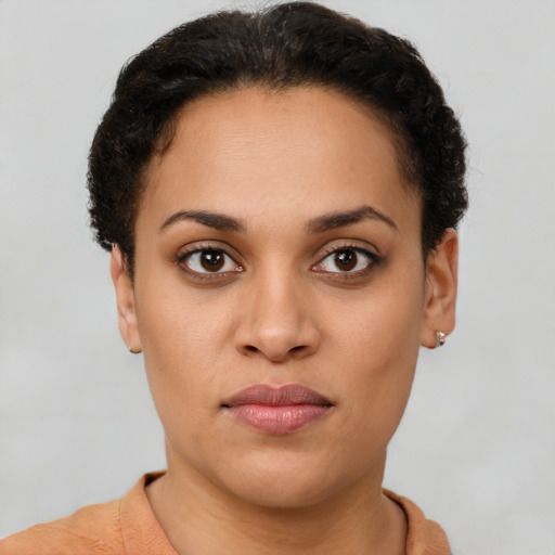 Joyful latino young-adult female with short  brown hair and brown eyes
