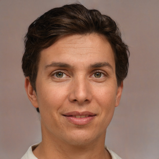 Joyful white adult male with short  brown hair and brown eyes